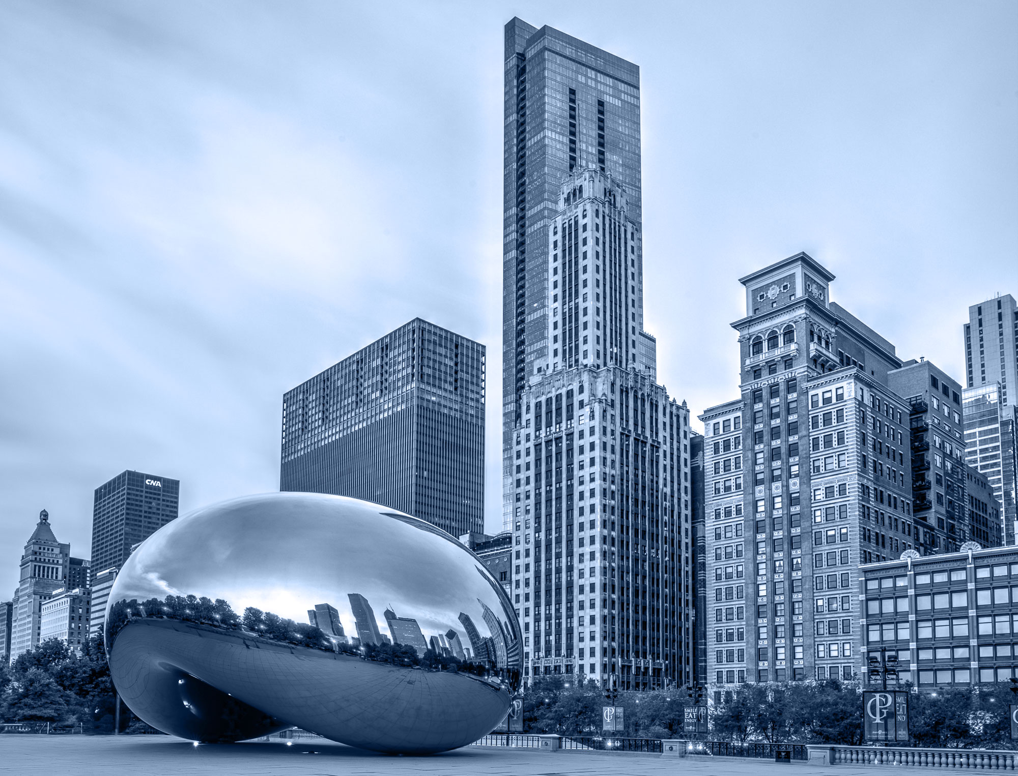 Millenium Park in Chicago, Illinois - highlighted by the Bean - a modern art piece - sitting in front of the skyline.